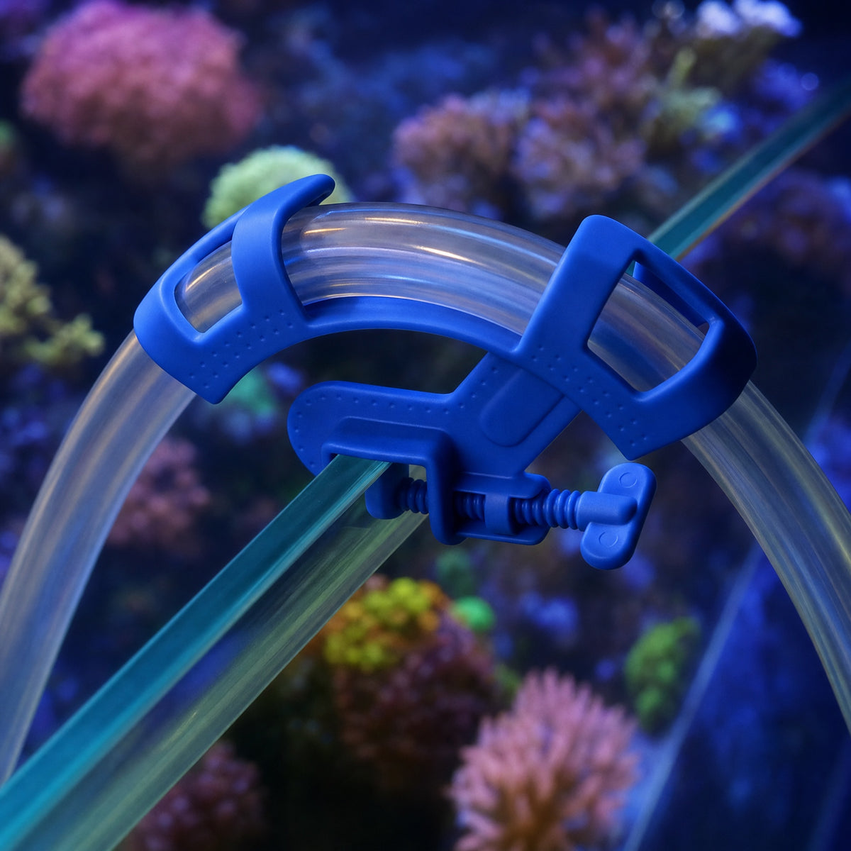 Reefphyto hose holder clamped on reef tank glass, holding a clear hose over the rim