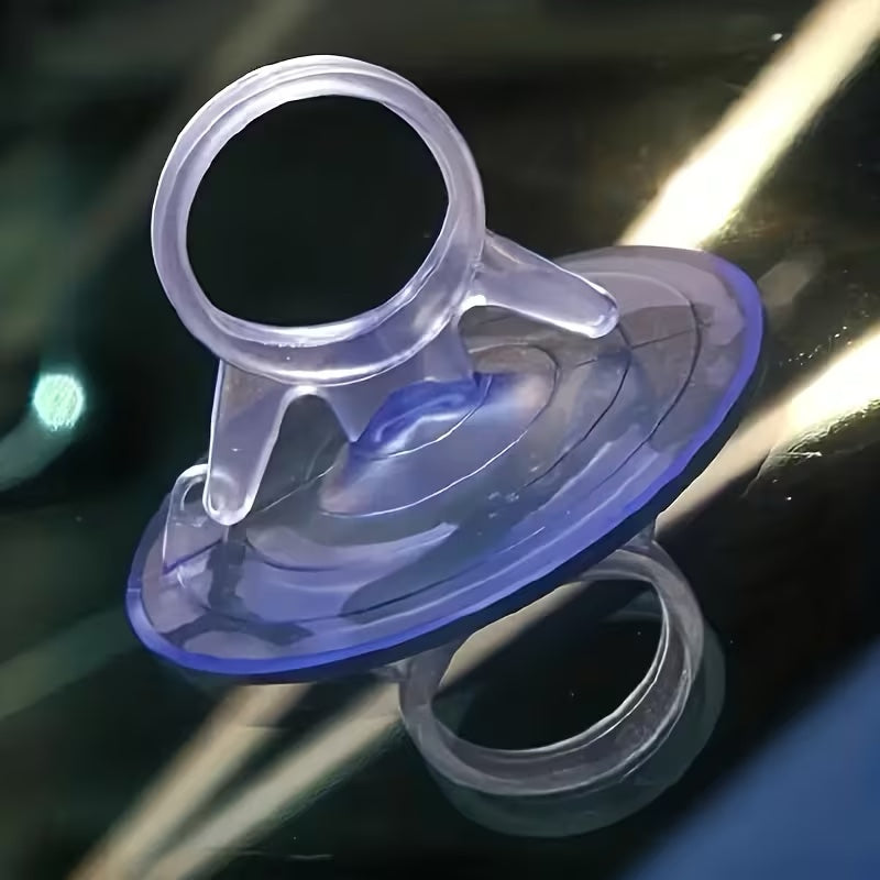 Close up of a clear aquarium suction cup showing the ring holder and release tab