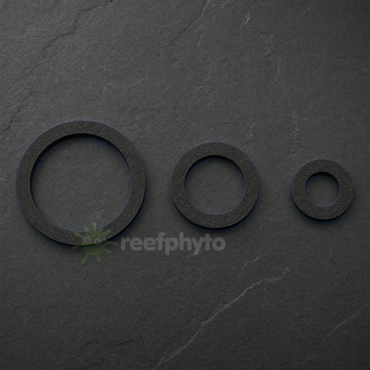 Three sizes of Reefphyto floating fish feeding ring laid out in a row