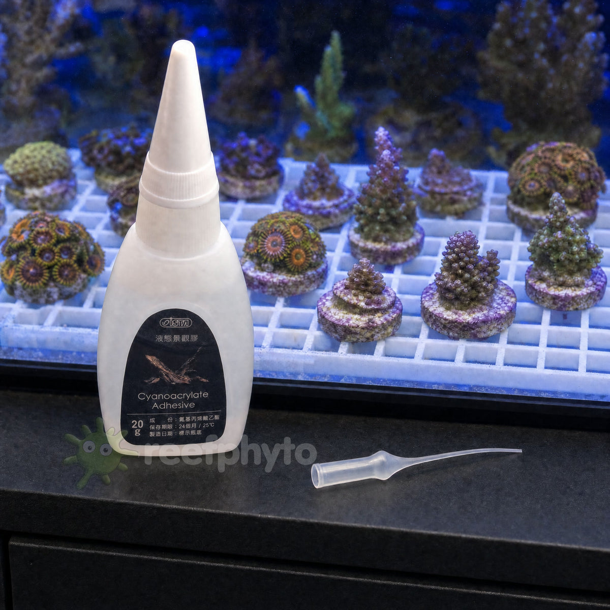 ISTA Cyanoacrylate Aquarium Glue in front of a frag rack of zoanthid and acropora frags on plugs
