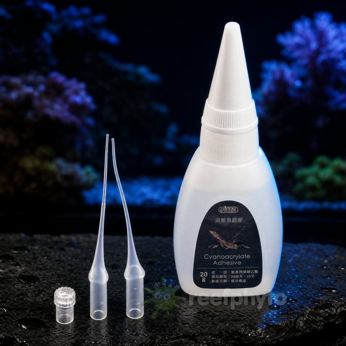 ISTA Cyanoacrylate Aquarium Glue 20g with two extender nozzles on wet slate in front of a reef tank