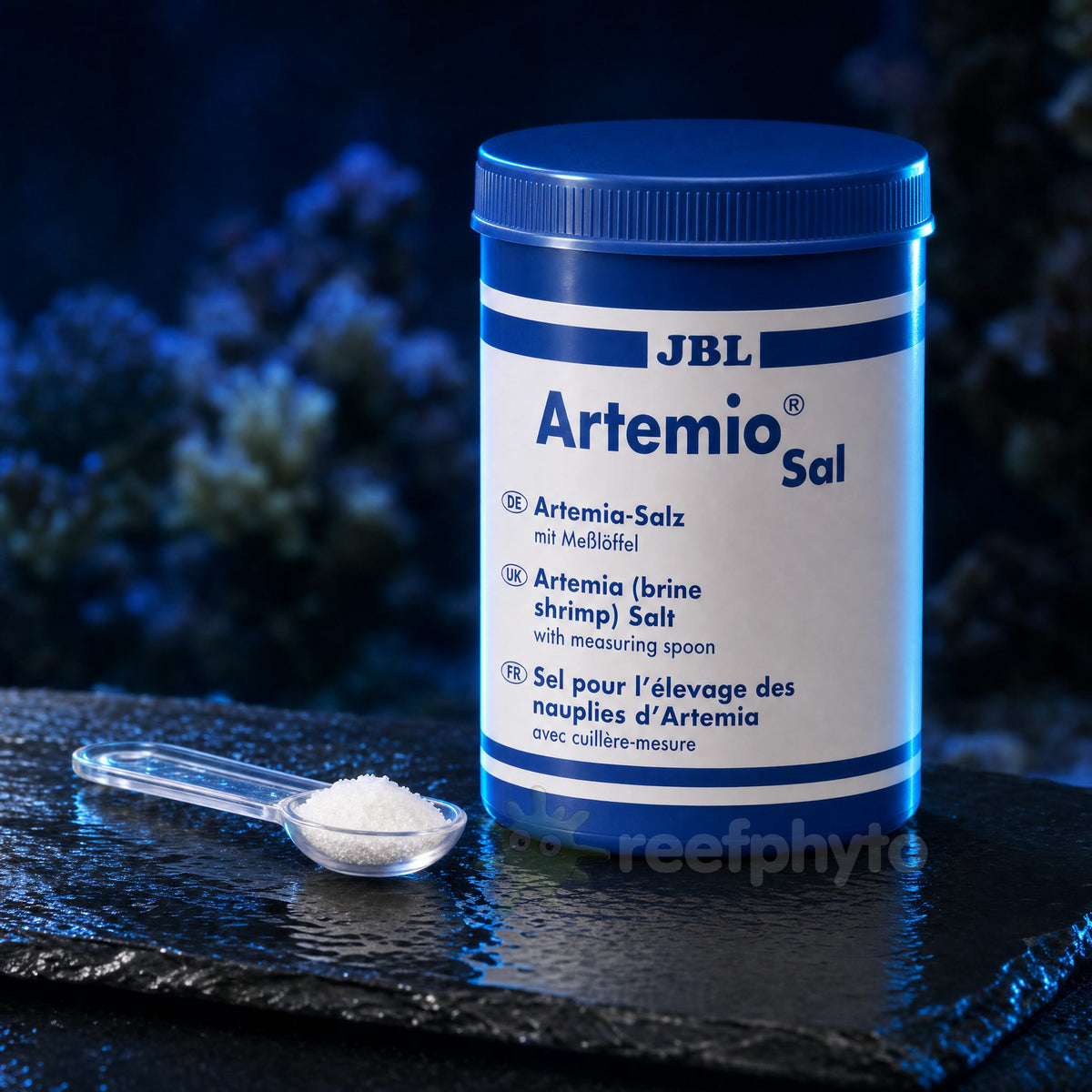 JBL ArtemioSal pot on wet slate with a measuring spoon of hatching salt in front of a reef tank