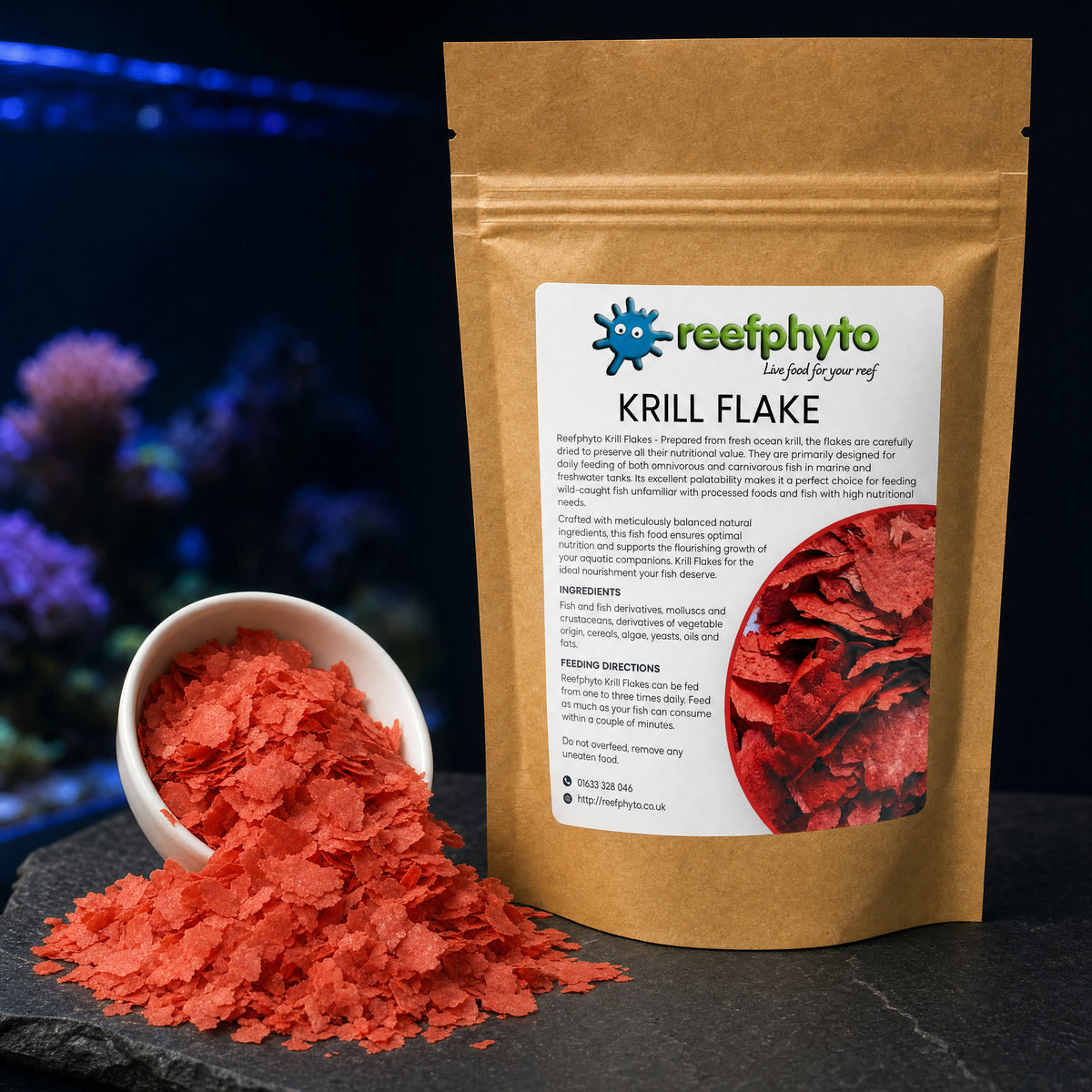 Reefphyto Krill Flake coral-red flakes in a white dish beside the pouch