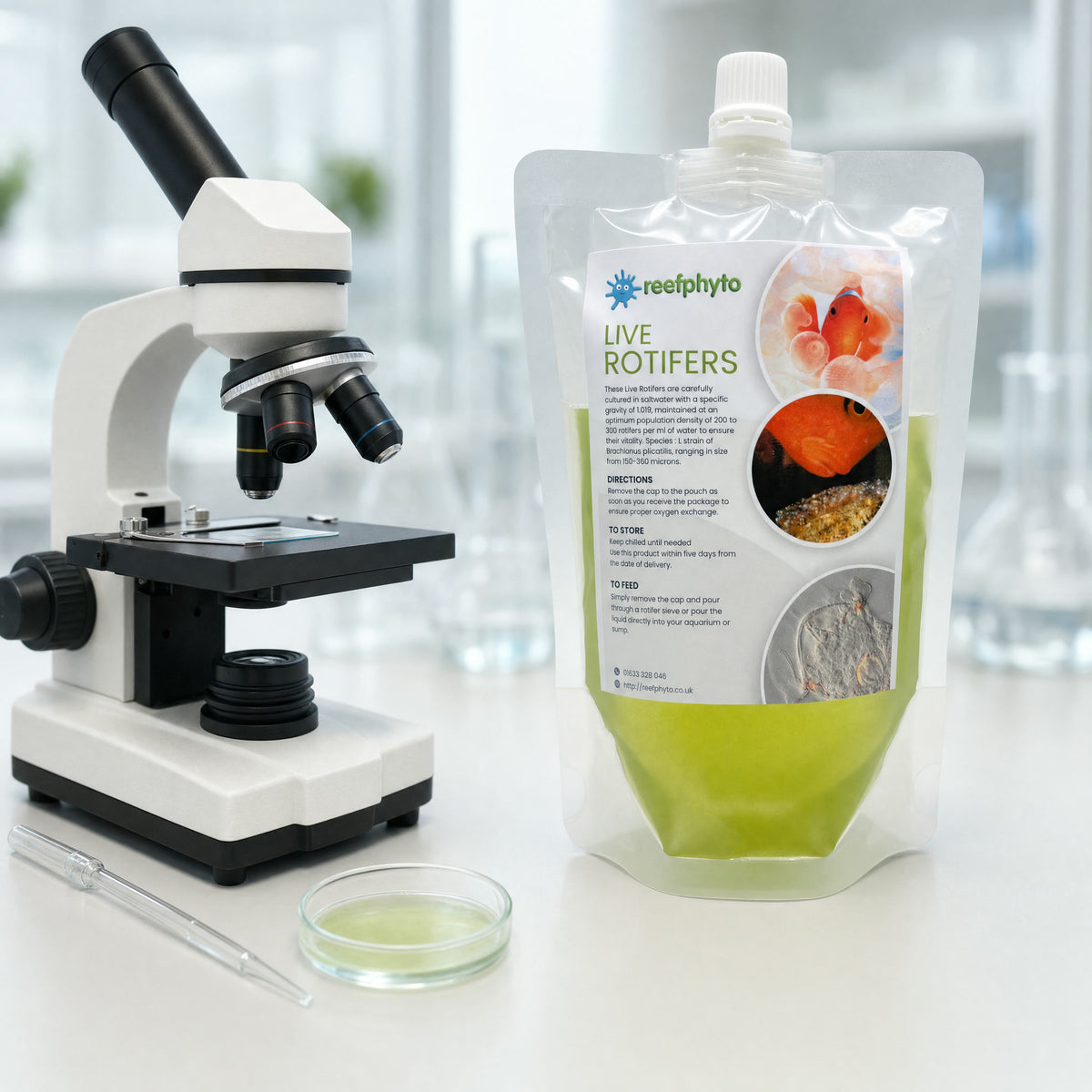 Reefphyto Live Rotifers pouch on a lab bench beside a microscope, pipette and petri dish of culture